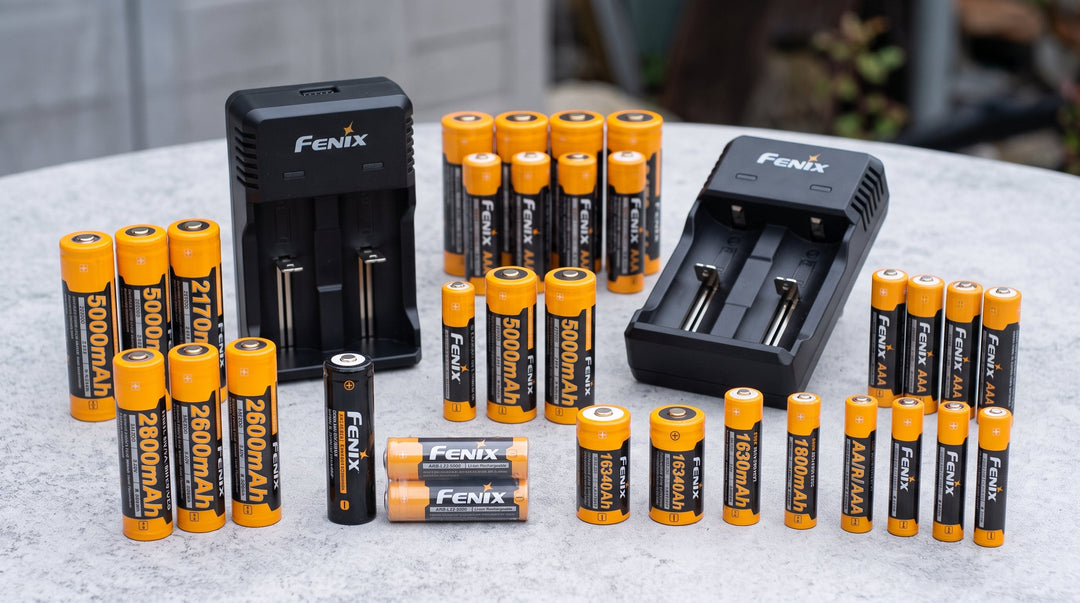 various batteries and chargers sitting on a table