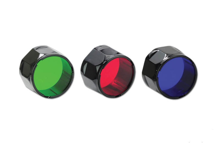 Three Fenix AOF-S+ filter adapters, colored green, red, and blue, displayed side by side.