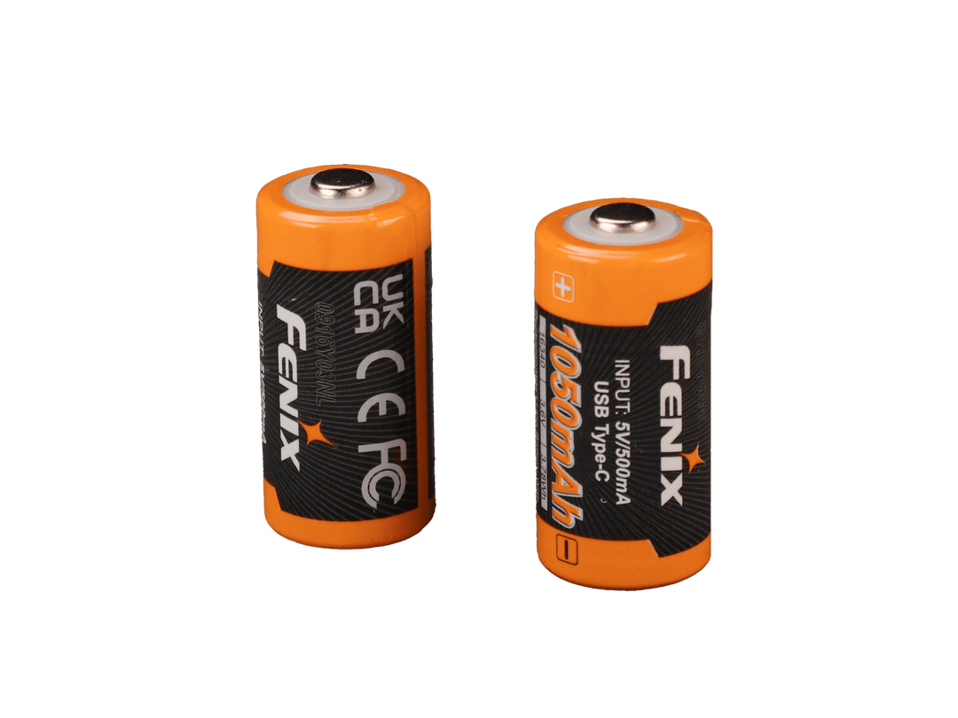 Two orange Fenix ARB-L16-1050UP USB Rechargeable 16340 batteries with black labels on a black background