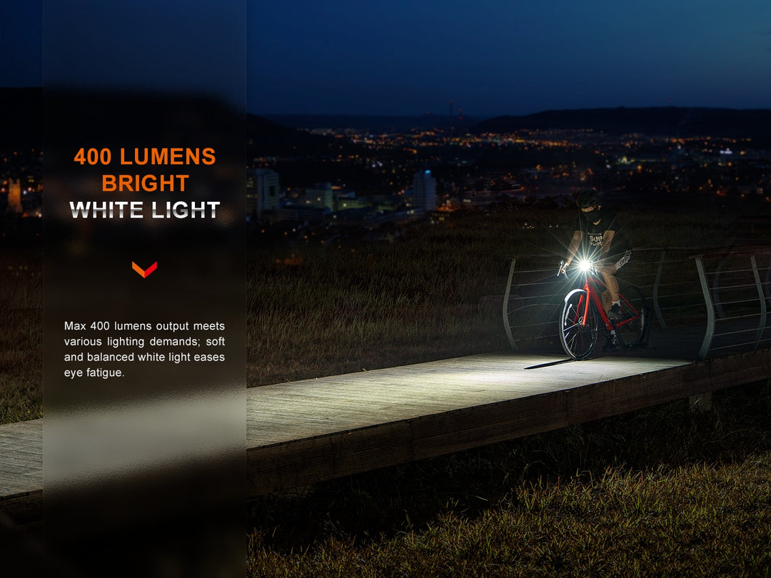A cyclist riding on a pier while using the Fenix BC15R Bike Light 