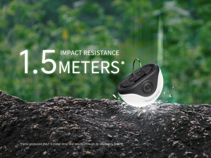 Black and white Fenix CL20R Pro camping lantern on a rock with '1.5 meters impact resistance' text against a green blurred background