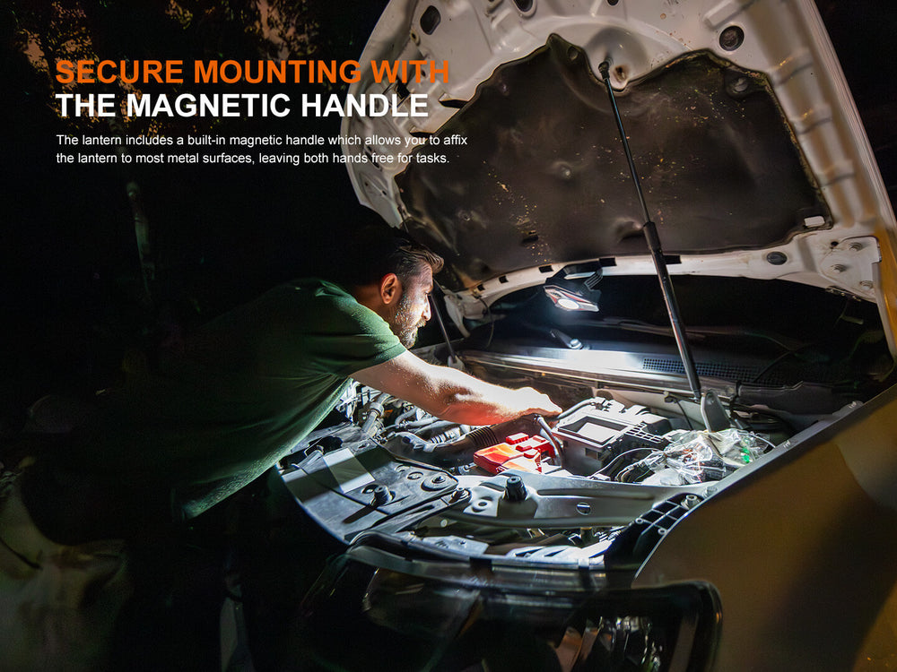 Person working under a car using the Fenix CP50R Road Hazard Camping Lantern's magnetic handle attached