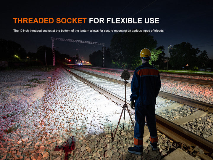 Person with a tripod and Fenix CP50R Road Hazard Camping Lantern on train tracks at night, with text about threaded socket.