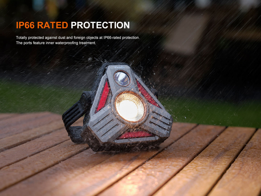 Fenix CP50R Road Hazard Camping Lantern with IP66 rating on a wooden surface in the rain.