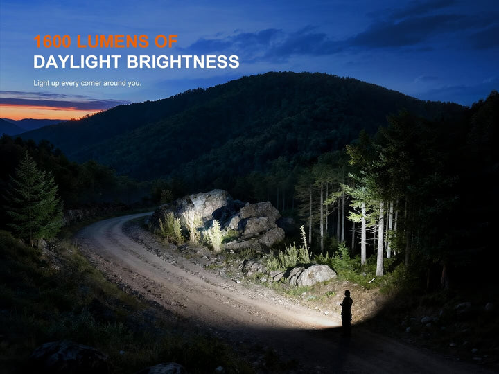 Person holding a Fenix E06R Flashlight on a mountain path with text about lumens of daylight brightness.