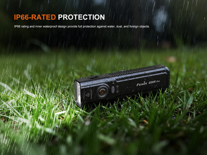 Black Fenix E06R Flashlight on grass with raindrops and IP66 rating text