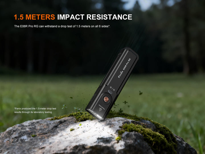 Black Fenix E06R Pro RG Green Laser Flashlight on a rock with '1.5 Meters Impact Resistance' text in an outdoor setting