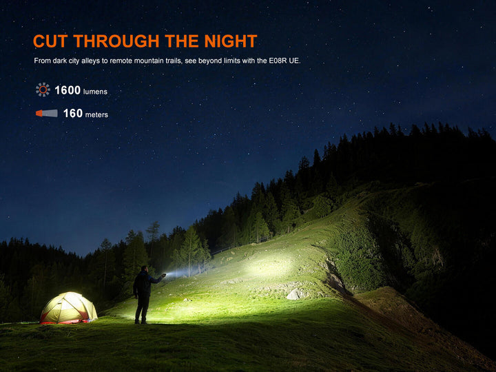 Fenix E08R UE EDC Flashlight used to light up a wood-covered hill