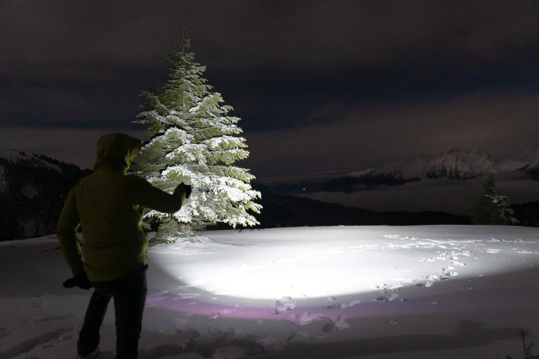 Fenix E08R UE EDC Flashlight used to illuminate a snowy field
