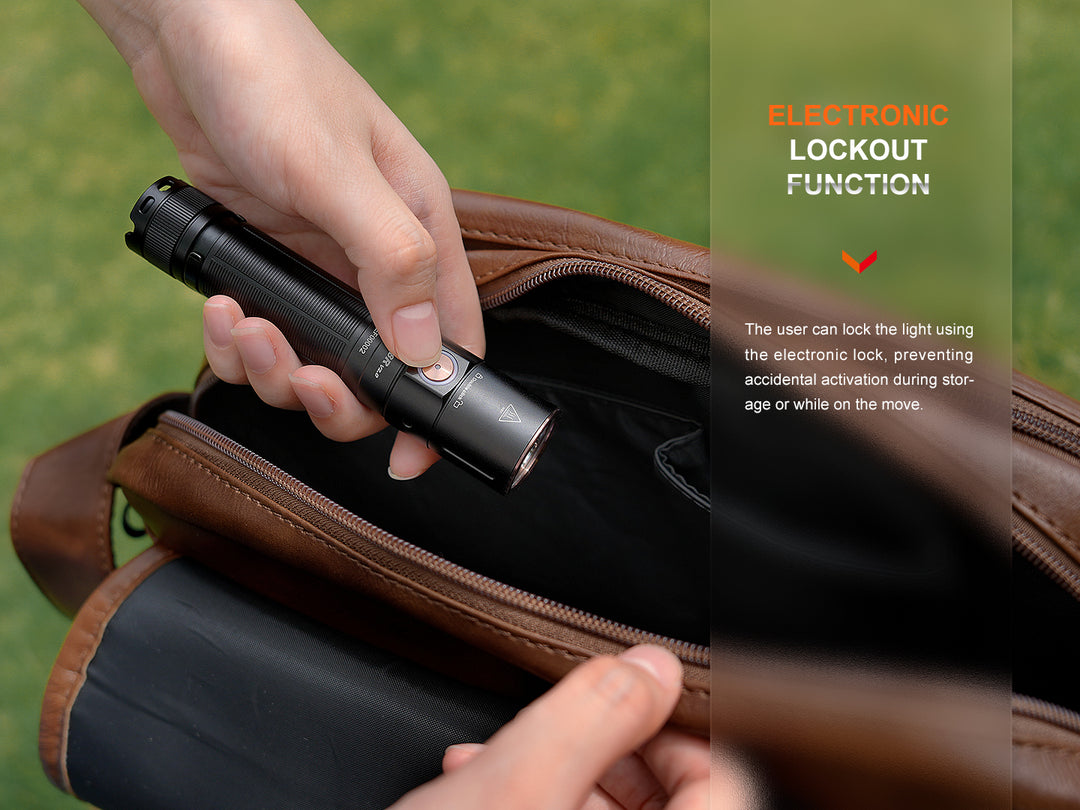 A person using the lock function of the Fenix E28R V2 rechargeable EDC flashlight as they put it in their bag