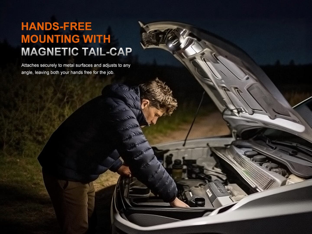 Person working on a car engine using the Fenix HM53R headlamp with magnetic tail-cap feature highlighted