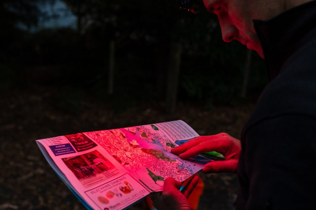 The red light of the Fenix HM53R headlamp used to read a map