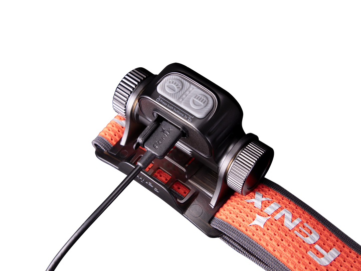 Fenix HM65R-T V2 rechargeable lightweight trail running headlamp with USB-C cable plugged in to charge