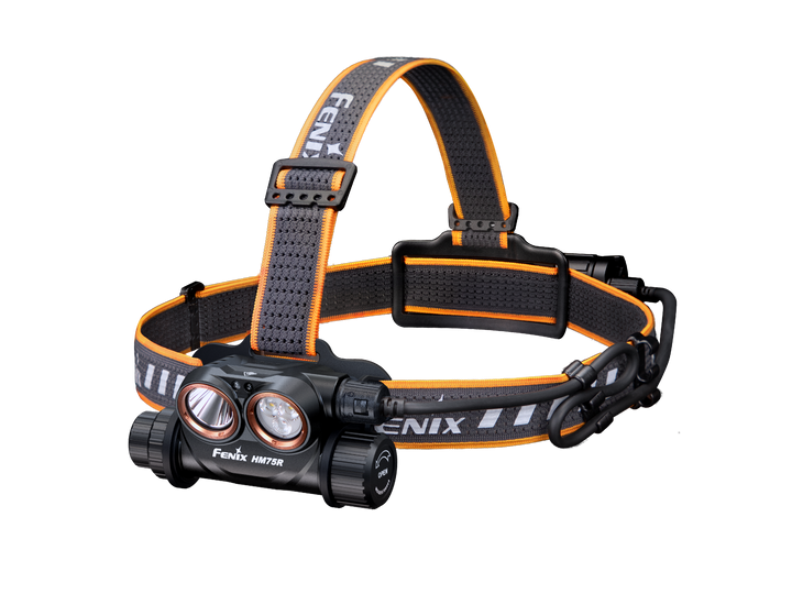 A black Fenix HM75R rechargeable industrial headlamp with an orange adjustment strap and white and red light sources, showcasing the front view with the brand name visible.