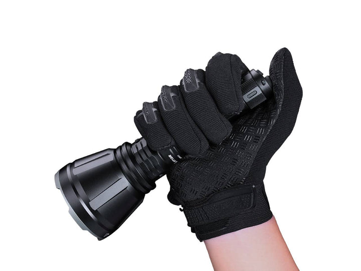 Fenix HT18R rechargeable hunting light held in a thumb grip