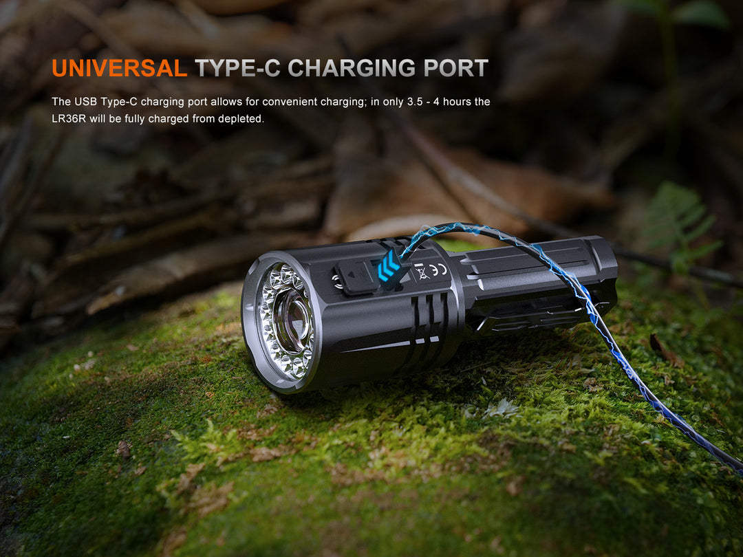 Fenix LR36R Searching Flashlight on mossy stone being charged via its USB-C charging port