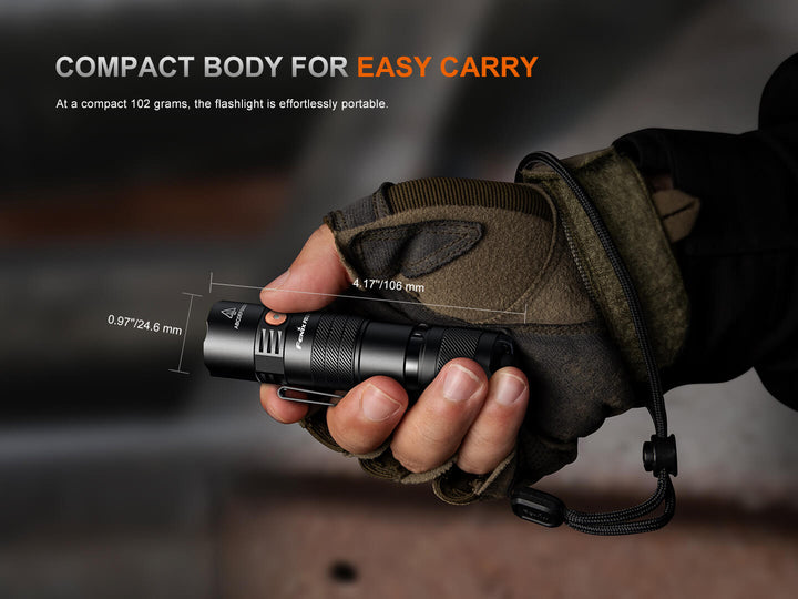 Hand holding a Fenix PD26R ACE Customizable Compact Flashlight with text highlighting its portability.