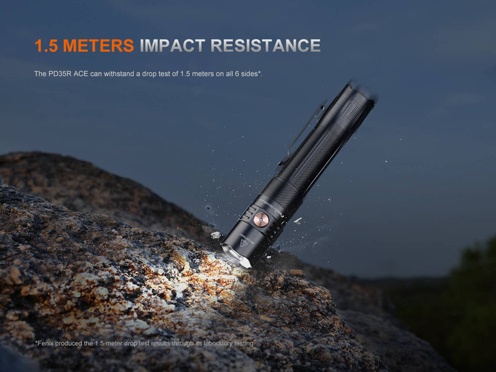Black Fenix PD35R ACE Customizable Flashlight  on a rock with text about impact resistance