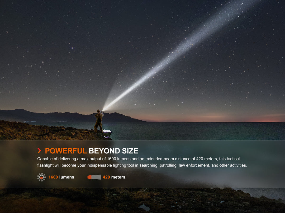 Fenix TK11R compact tactical flashlight shining up into the sky