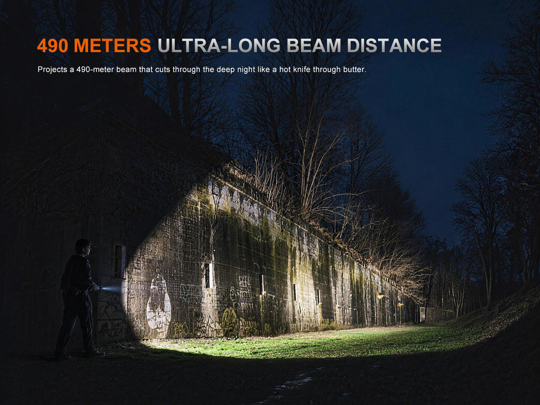 Person using a Fenix TK15R adaptive flashlight to illuminate an old building at night with text about ultra-long beam distance.