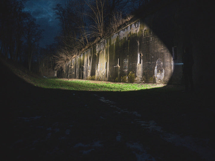Abandoned building in a dark forest at night