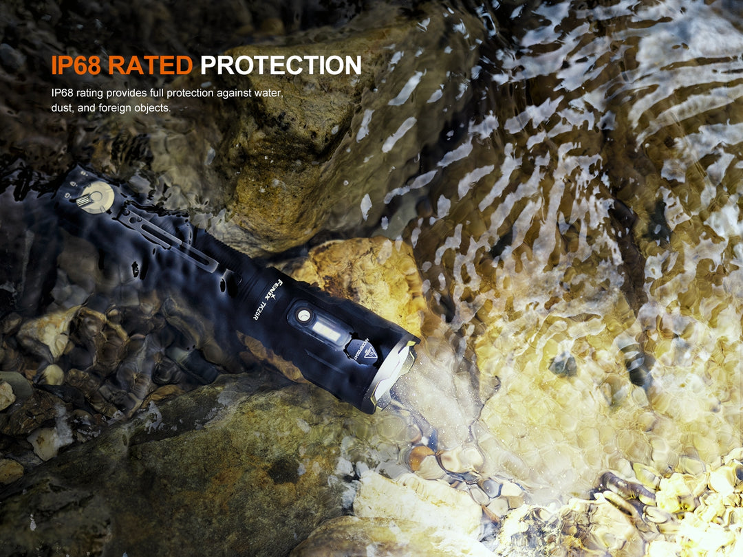 Fenix TK25R Tactical Flashlight on a rocky surface under water, highlighting IP68 rating.