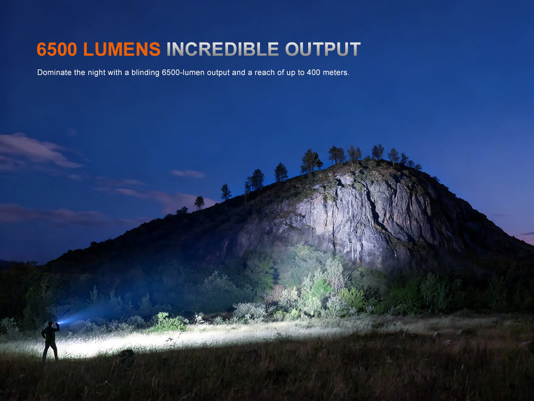 Person using a flashlight to illuminate a mountainous landscape with text about 6500 lumens output.