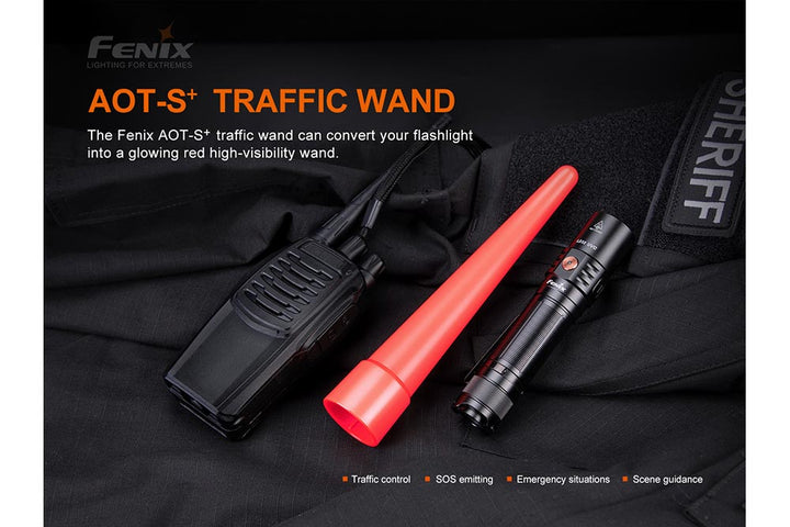 Fenix AOT-S+ Traffic Wand on black fabric next to a radio and a flashlight