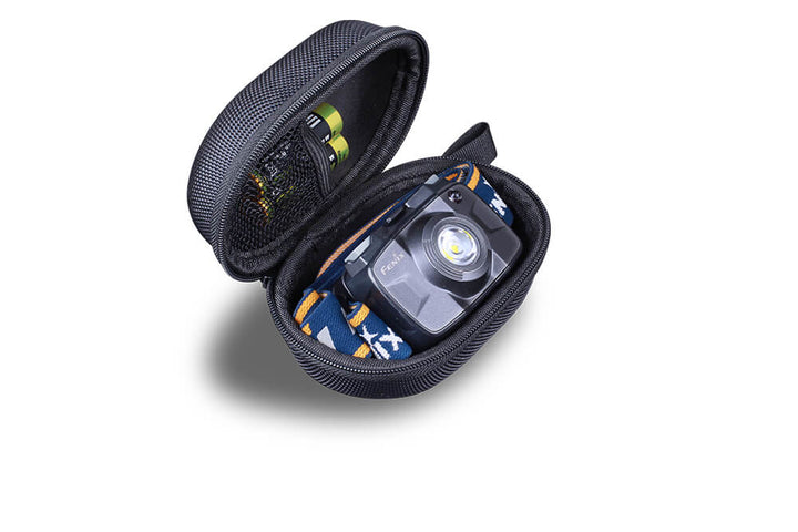 A black Fenix APB-20 headlamp storage bag open, displaying a headlamp and accessories neatly organized inside.