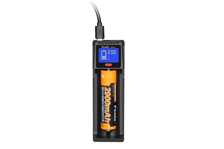 A black Fenix ARE-D1 single channel smart battery charger with an orange battery inserted, displaying charge information on a blue LCD screen.