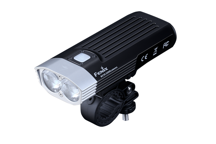 A black Fenix BC30 V2 LED bike light with dual LED lights, mounted on a bike light mount.