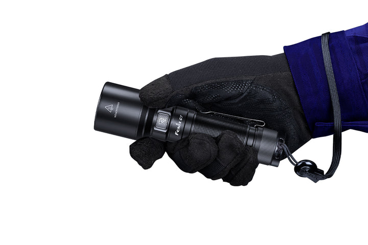  Fenix C7 rechargeable LED flashlight held in a gloved hand