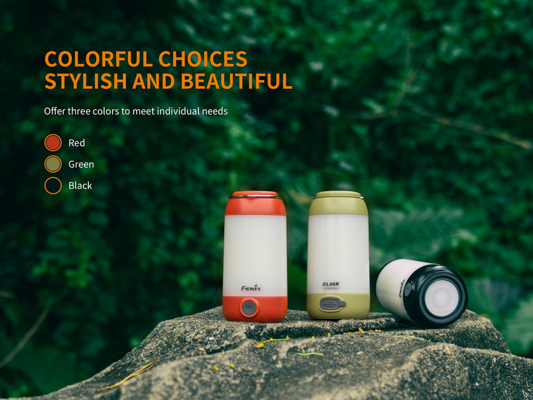 Fenix CL26R Camping Lantern in three colors sitting on stone in the woods