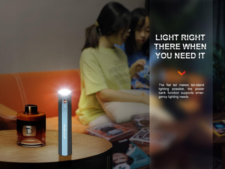 Fenix E-CP Powerbank Flashlight standing on a table, acting as a candle