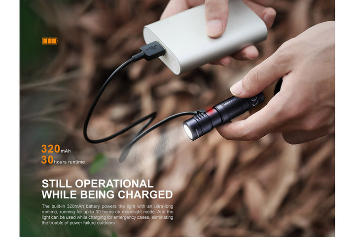 Fenix E05R Mini Keychain LED Flashlight being used while charging