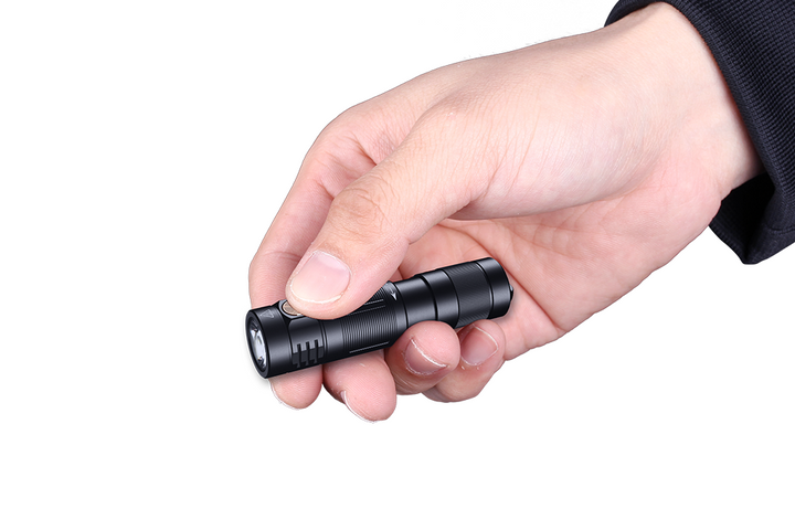 Fenix E09R rechargeable flashlight held in hand