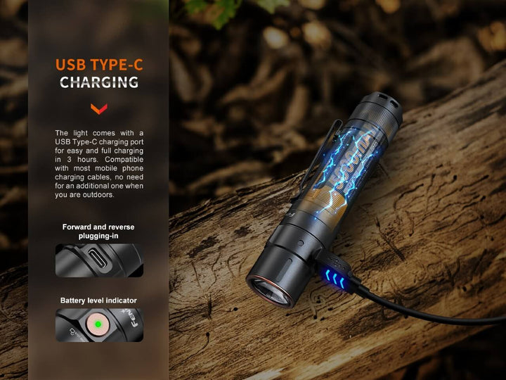 Fenix E35R high-performance rechargeable LED flashlight charging while sitting on a log