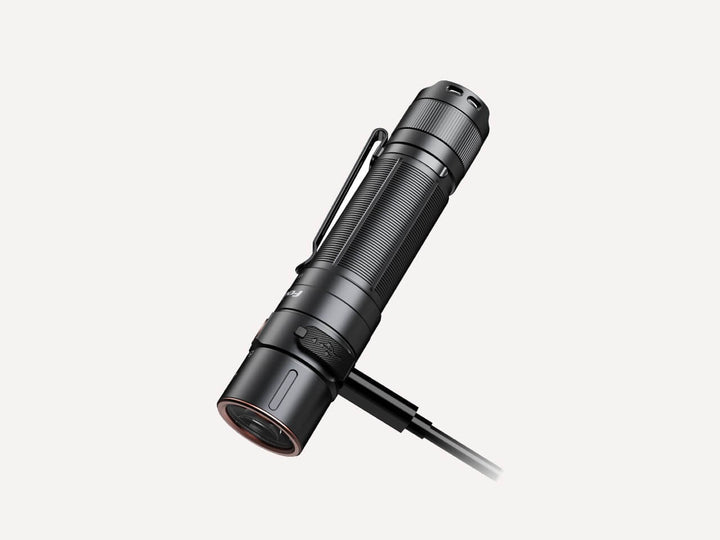 Fenix E35R high-performance rechargeable LED flashlight plugged in to charge
