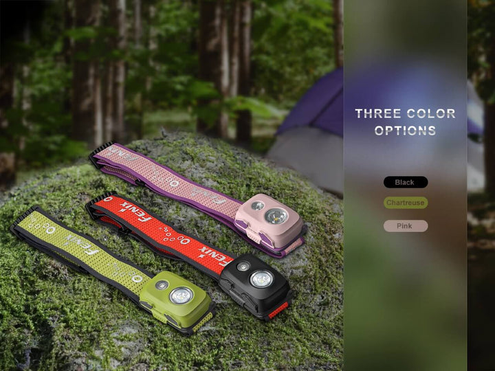 Fenix HL16 lightweight hiking headlamp in three colors sitting on stone