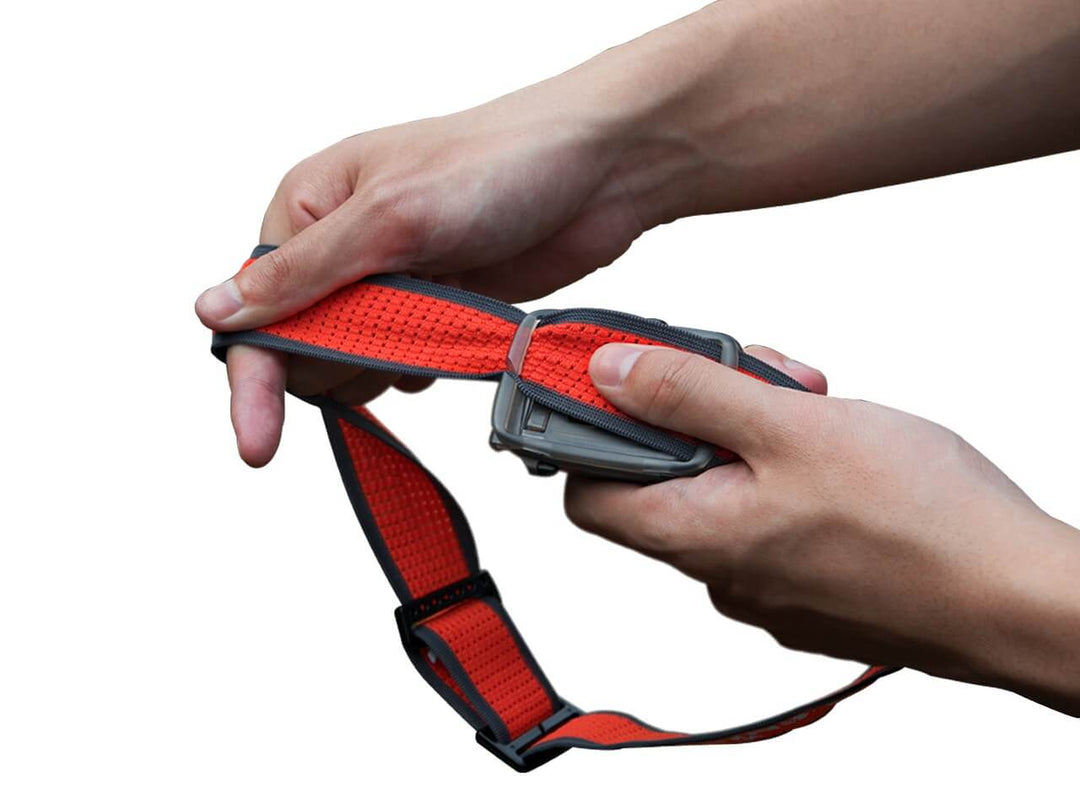 Fenix HL16 lightweight hiking headlamp being removed from headlamp