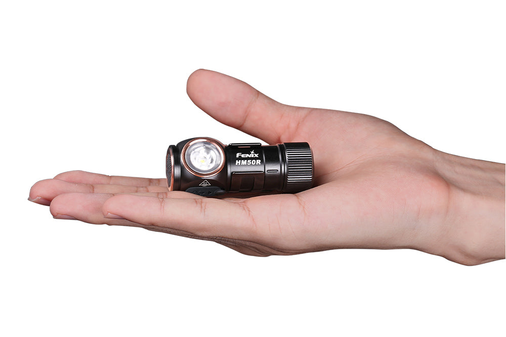 Fenix HM50R V2 LED headlamp held in a hand