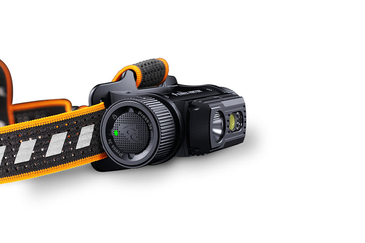 Fenix HM70R rechargeable headlamp on white background as viewed from the left side, showing the switch