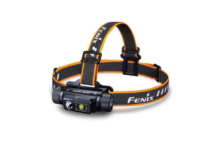 A black Fenix HM70R rechargeable LED headlamp with an orange and black adjustable strap, featuring a LED light source on the front.
